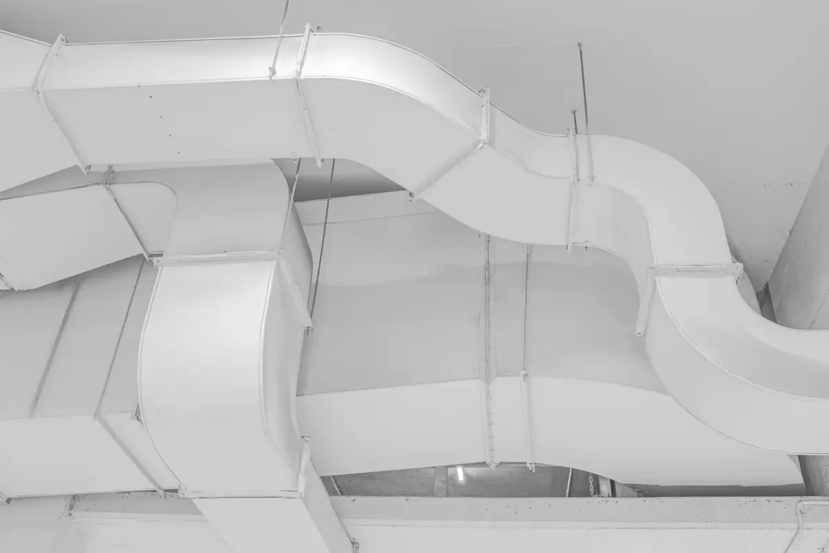 White ventilation ducts under a ceiling